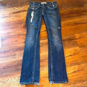 Ladies jeans with a floral patch.